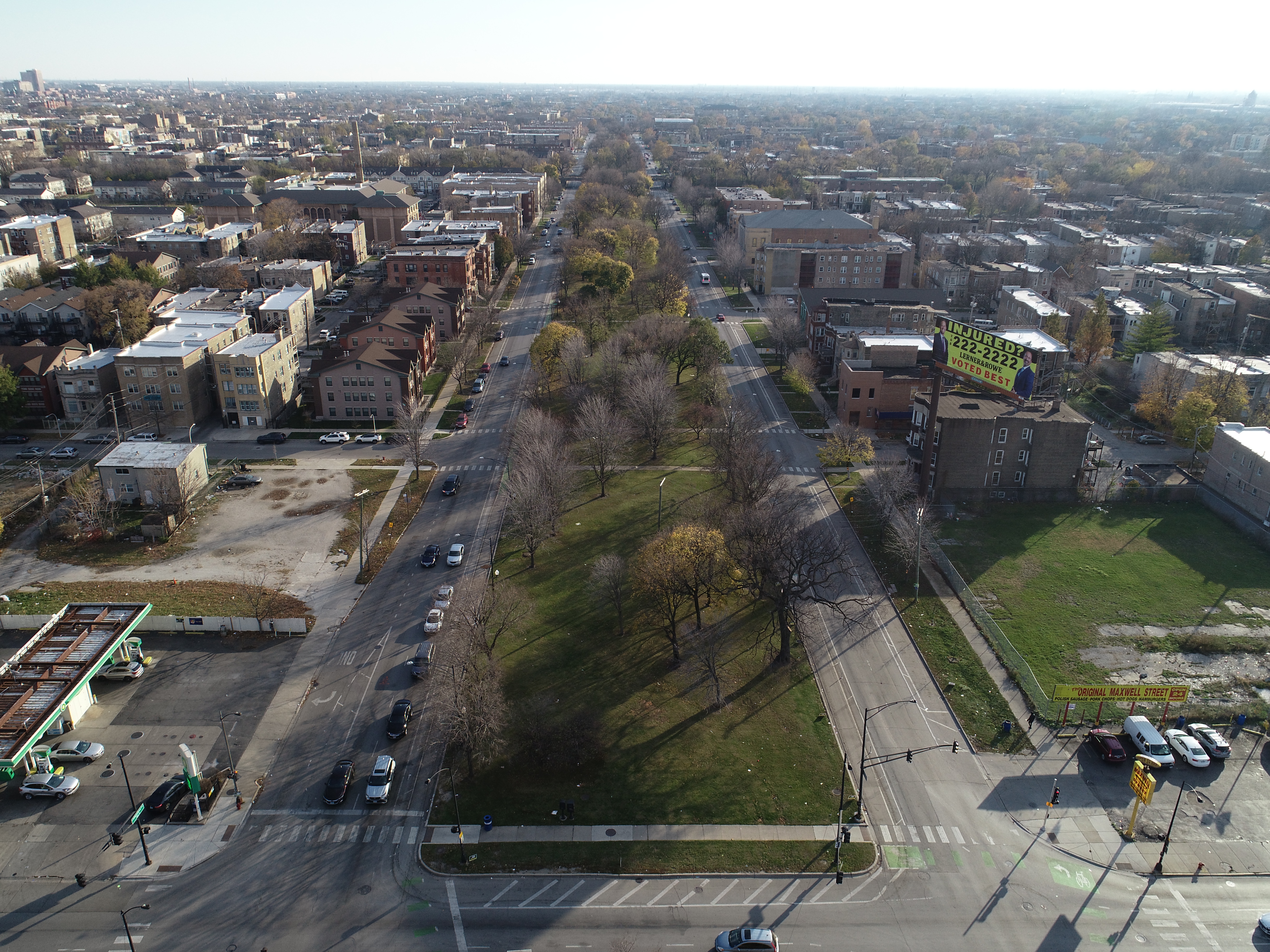 Aerial view of boulevard with large central green space and street surrounding on both sides.
